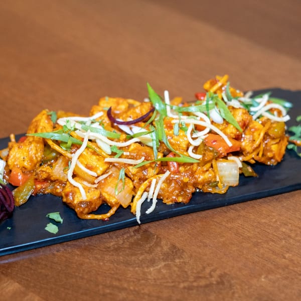 Chilli Paneer from The Yellow Chilli, a vibrant Indian dish with paneer, peppers, and onions.